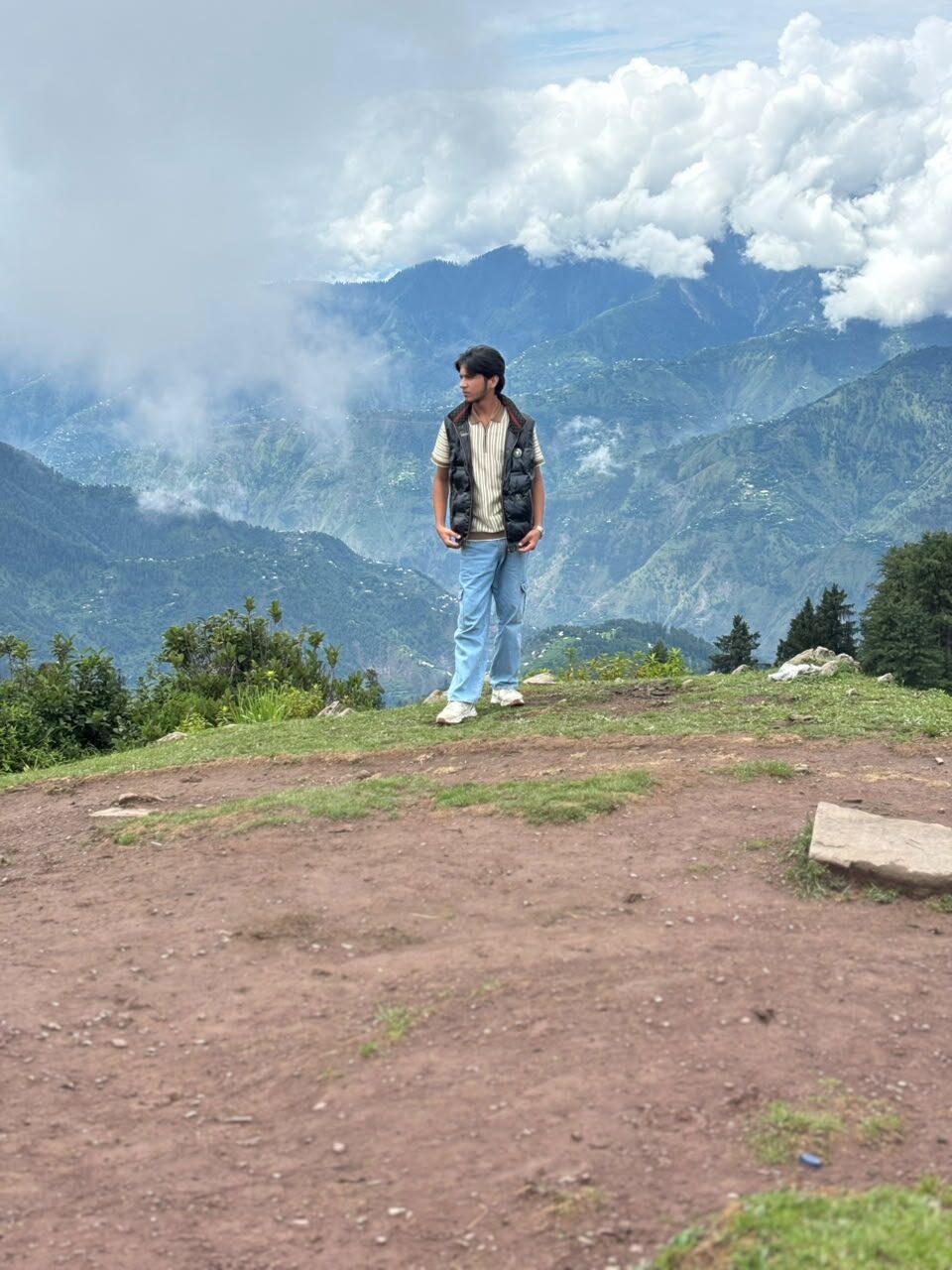 Ahmad Safdar overlooking cloud-covered mountains