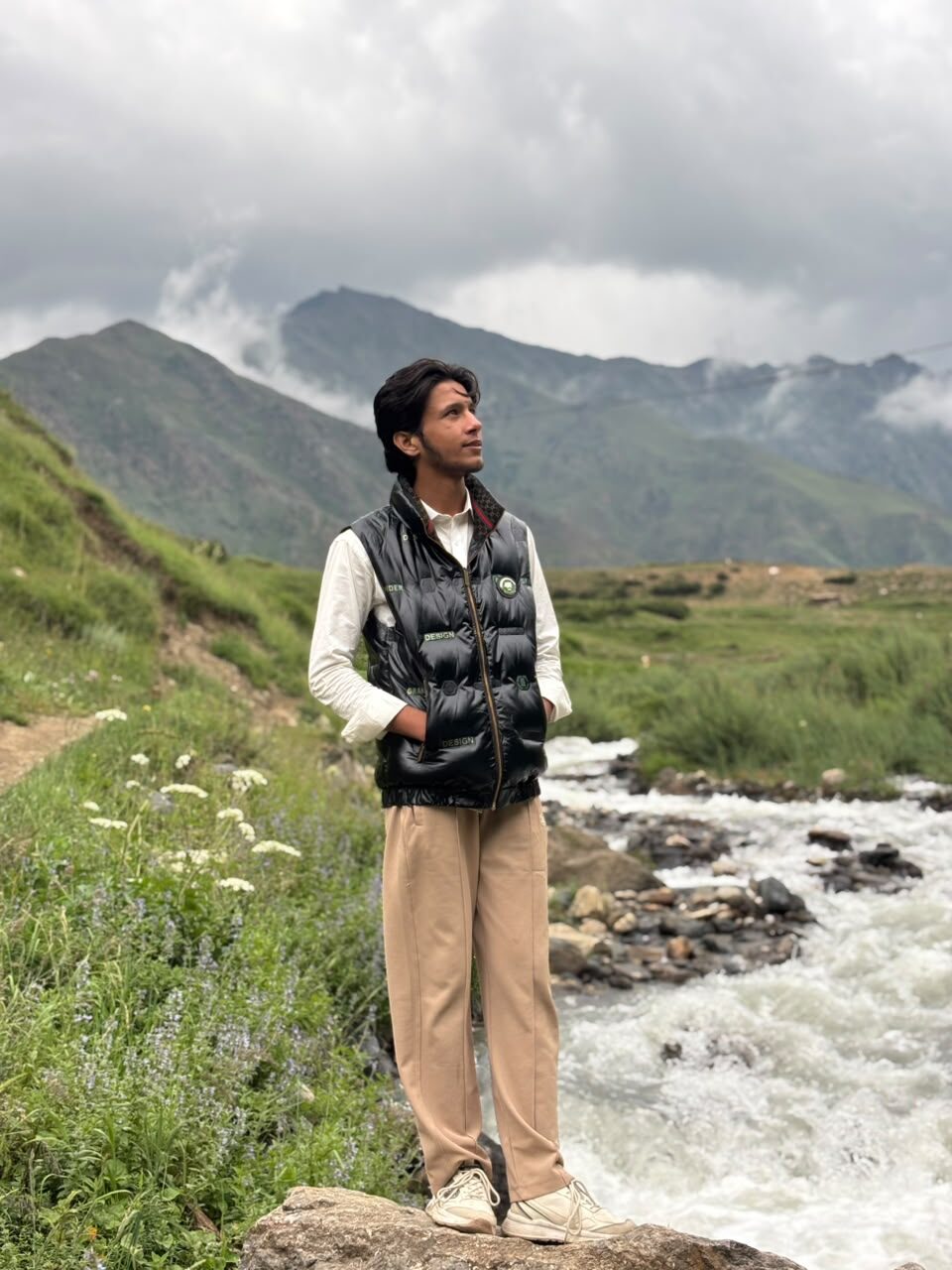 Ahmad Safdar beside a mountain stream